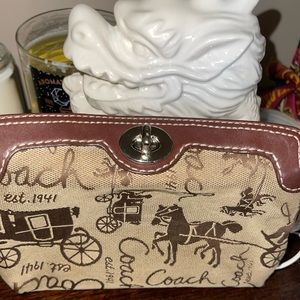 Brown and tan Coach turn lock wristlet
